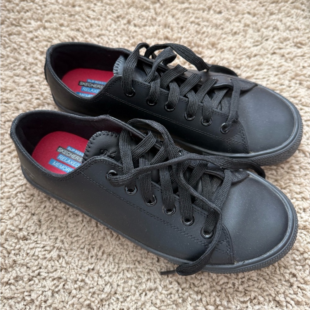 Black Skecher work shoes.